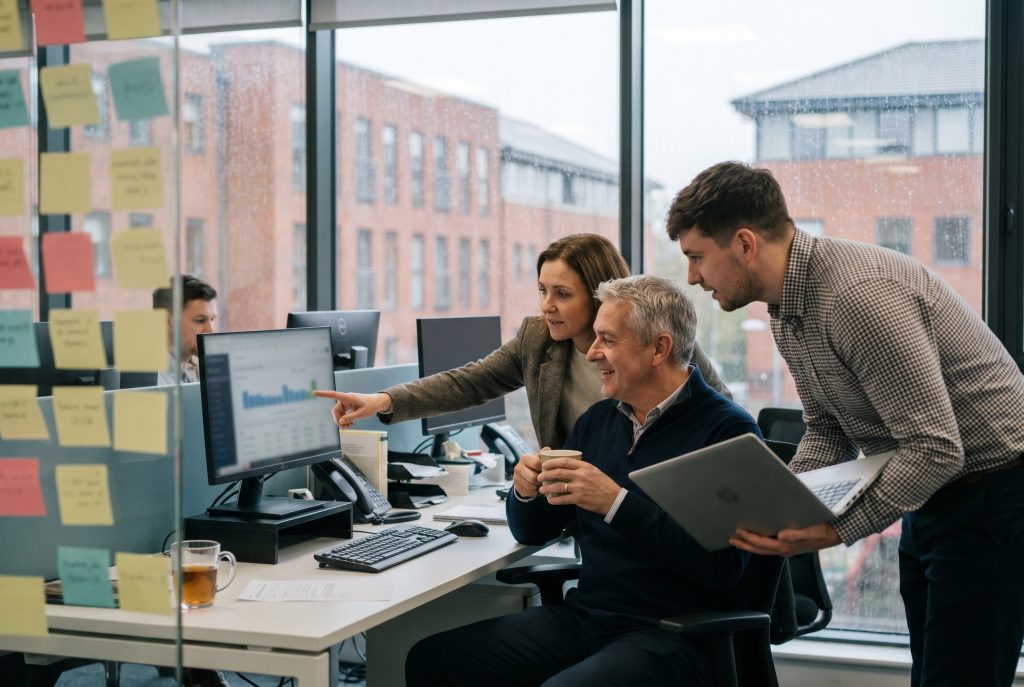 Recruitment agency team reviewing contingent workforce compliance on screen in a UK office